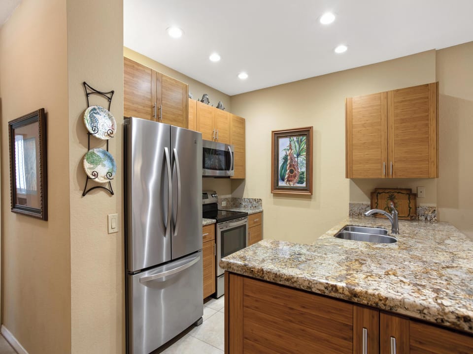 Your well-appointed kitchen features warm wood cabinetry, gleaming granite countertops, and modern stainless steel appliances—everything you need to whip up a delicious meal during your stay.