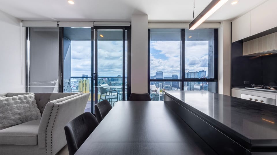 Open dining area seamlessly connected to the balcony and city views