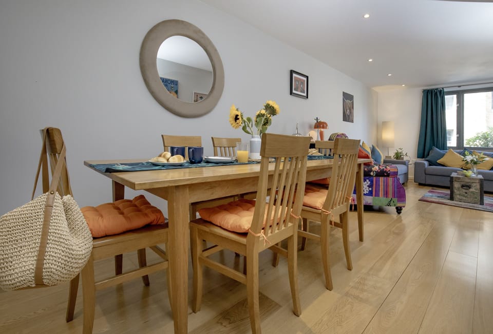Mariner's Retreat, Dartmouth. This spacious, open-plan dining area flows seamlessly into the comfortable sitting room, creating an inviting space perfect for entertaining.