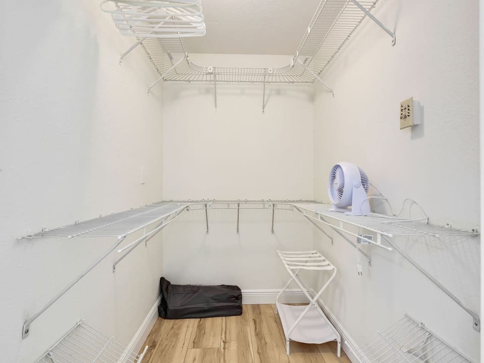 The master bedroom boasts a full walk in closet