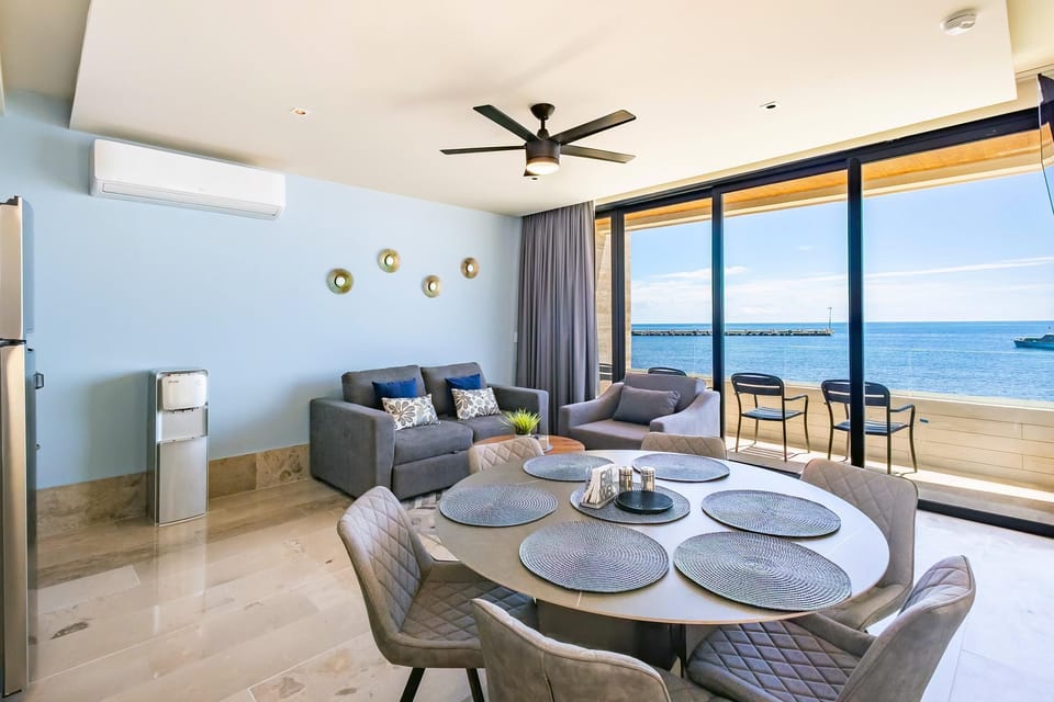 Sunlit dining area with panoramic ocean views and cozy living space