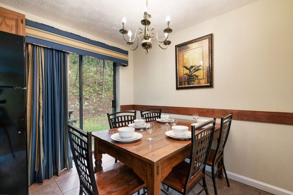 Enjoy meals together in the dining area with forest views and warm cabin charm.