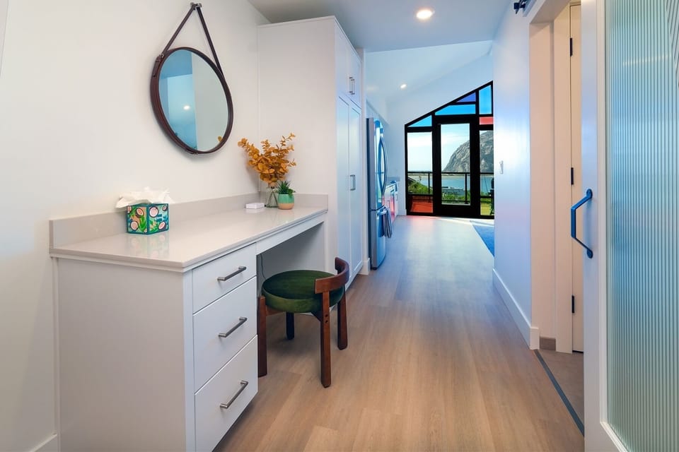 The hallway provides a dedicated working space with desk and charging station
