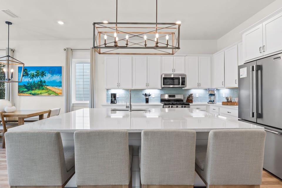 The granite eat-in island is both a functional centerpiece and a stylish focal point of the kitchen.
