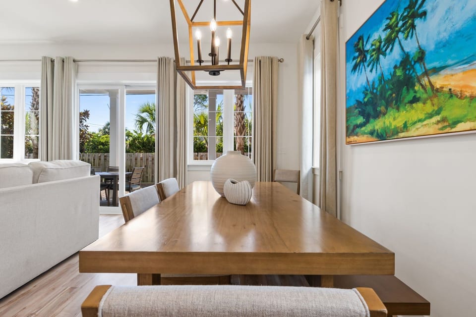 Bathed in natural light, it features a stylish table with seating for six or more, making it ideal for everything from casual breakfasts to celebratory dinners.