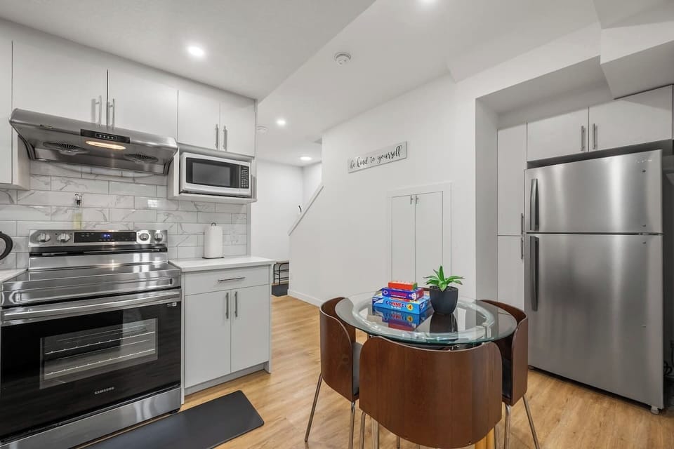 Fully equipped kitchen with stainless steel appliances and dining area