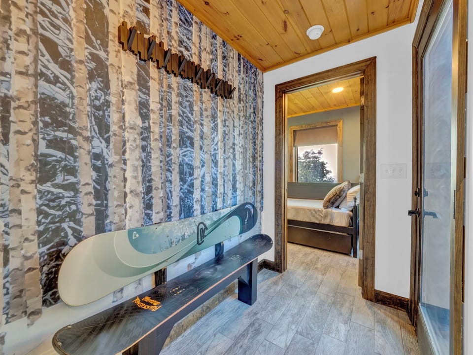 Ski and snowboard gear nook with wall hooks and a bench—perfect for storing your adventure essentials.