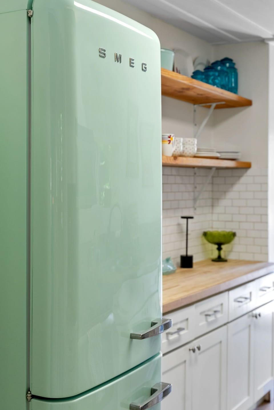 Retro mint-green SMEG fridge adds a playful pop of color and vintage charm