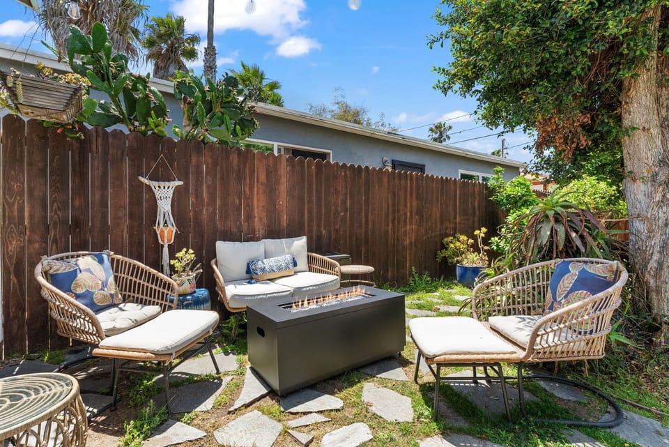 Private backyard oasis with cozy seating and fire pit for relaxing evenings.