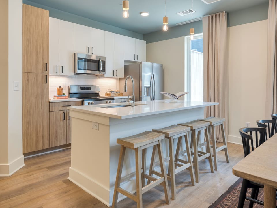 Fully equipped kitchen with barstool seating.