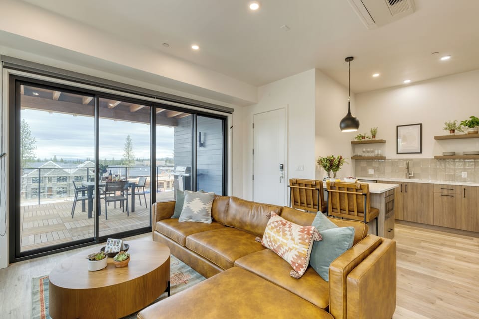 Bright open living area with deck access and modern kitchen.