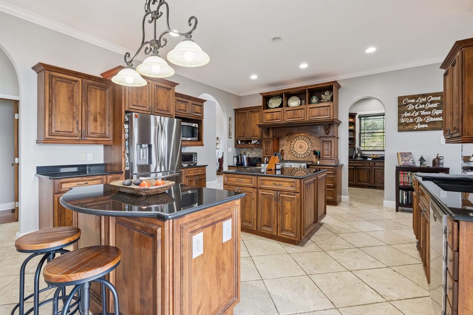 Large kitchen with multiple islands and bar seating areas
