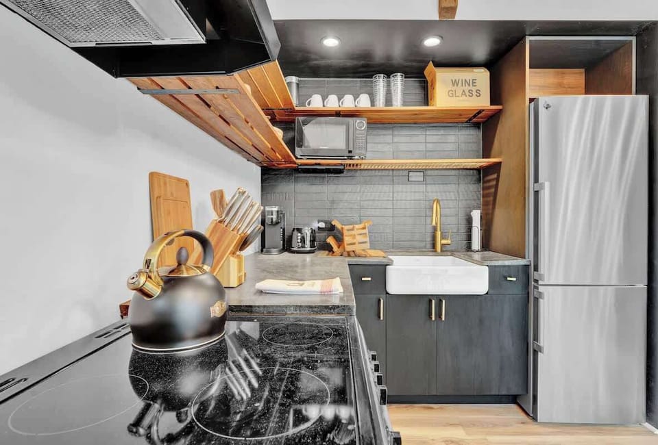 Stylish Cabin Kitchen with Open Shelving and Stainless Appliances