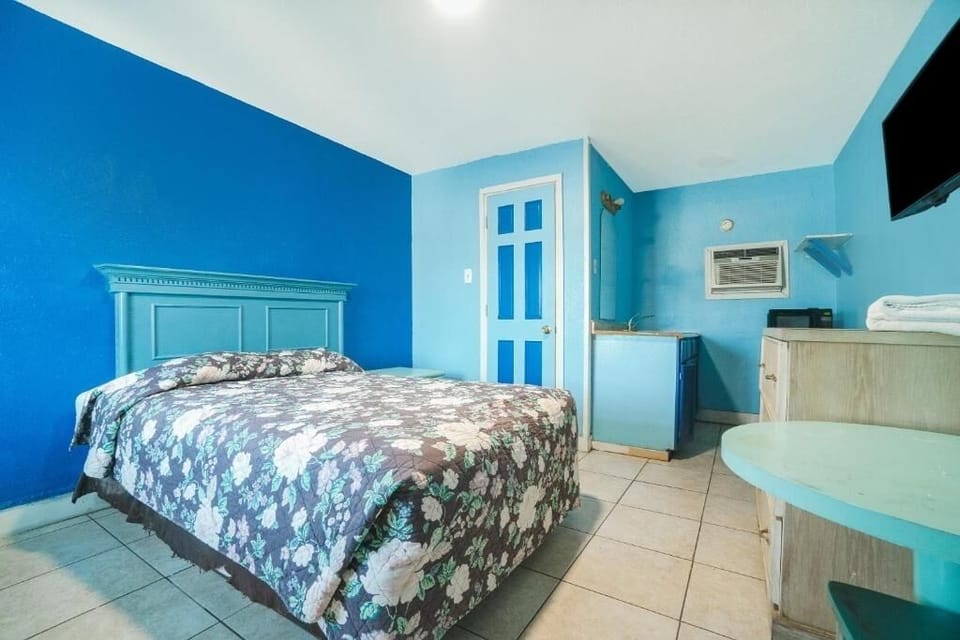 Unwind on the plush bed in this bright, airy retreat.