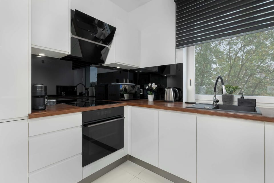 The kitchen's contemporary decor complements the apartment's style.