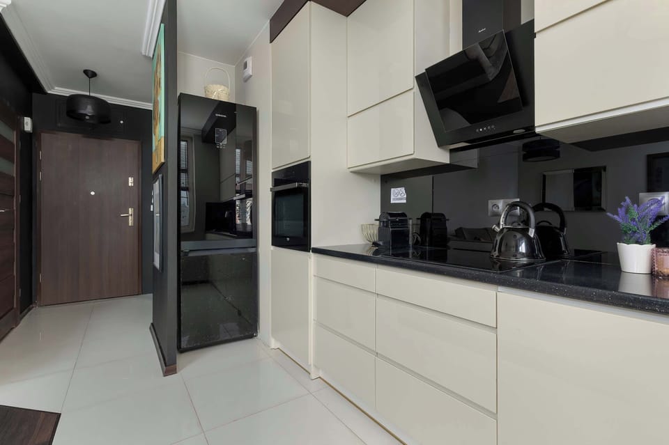 The elegant kitchen with modern cabinetry and black finishes creates a stylish space perfect for cooking.