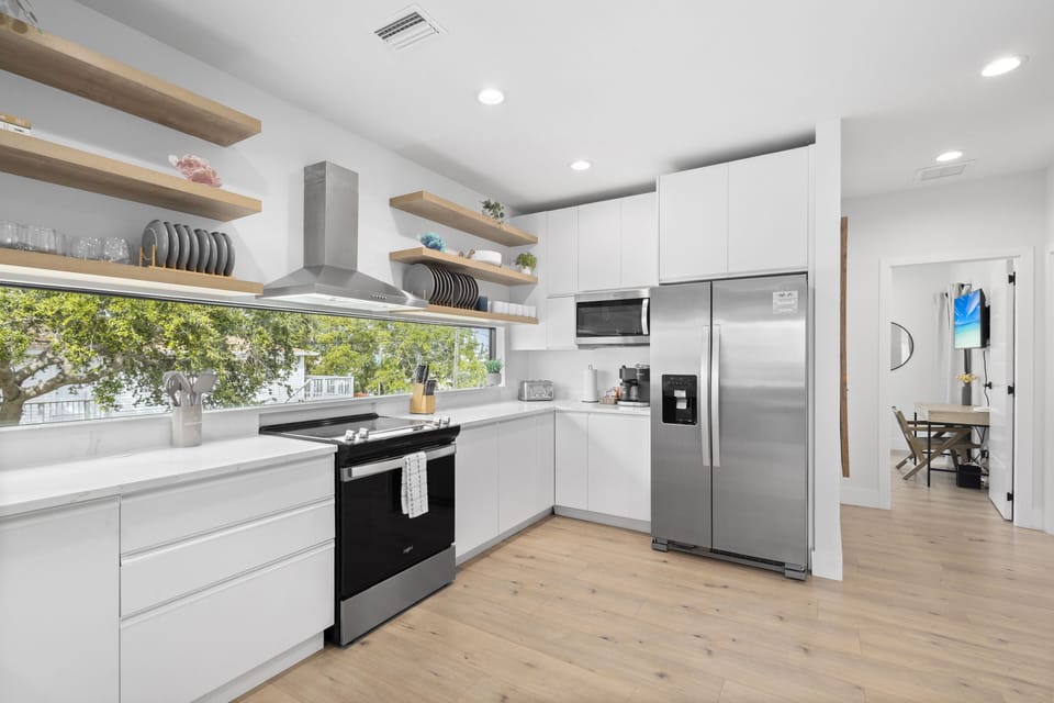 Cook up delicious meals and enjoy memorable moments in this bright, modern kitchen, designed for effortless entertaining and relaxing with loved ones during your stay.