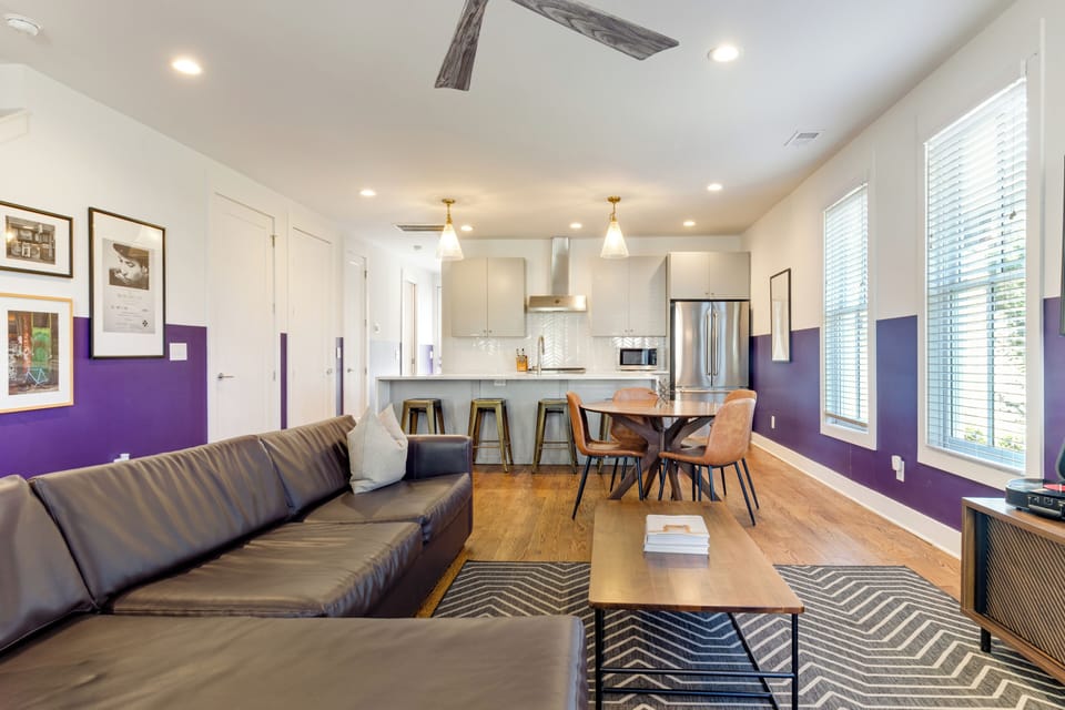 A sleek living space with bold color accents and cozy seating.