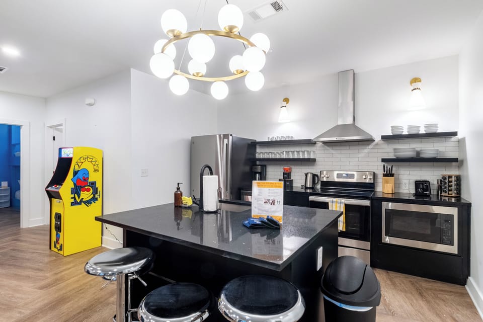 Kitchen features an island with barstool seating.