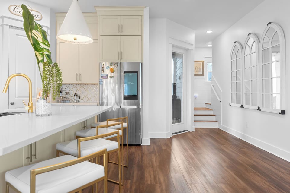Sleek kitchen entry with hardwood floors.