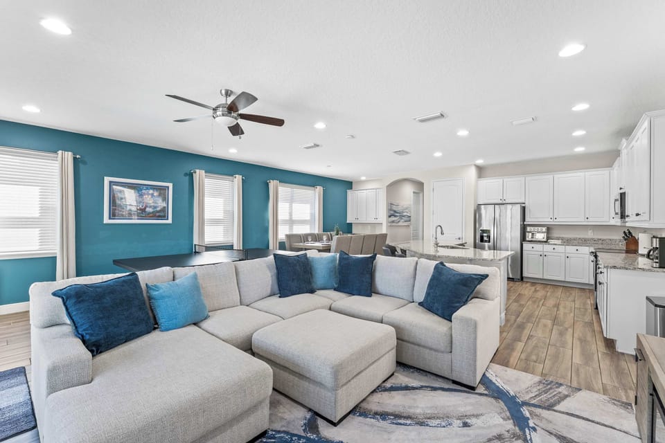 Bright open living area with Smart TV, ping pong table, and dart board