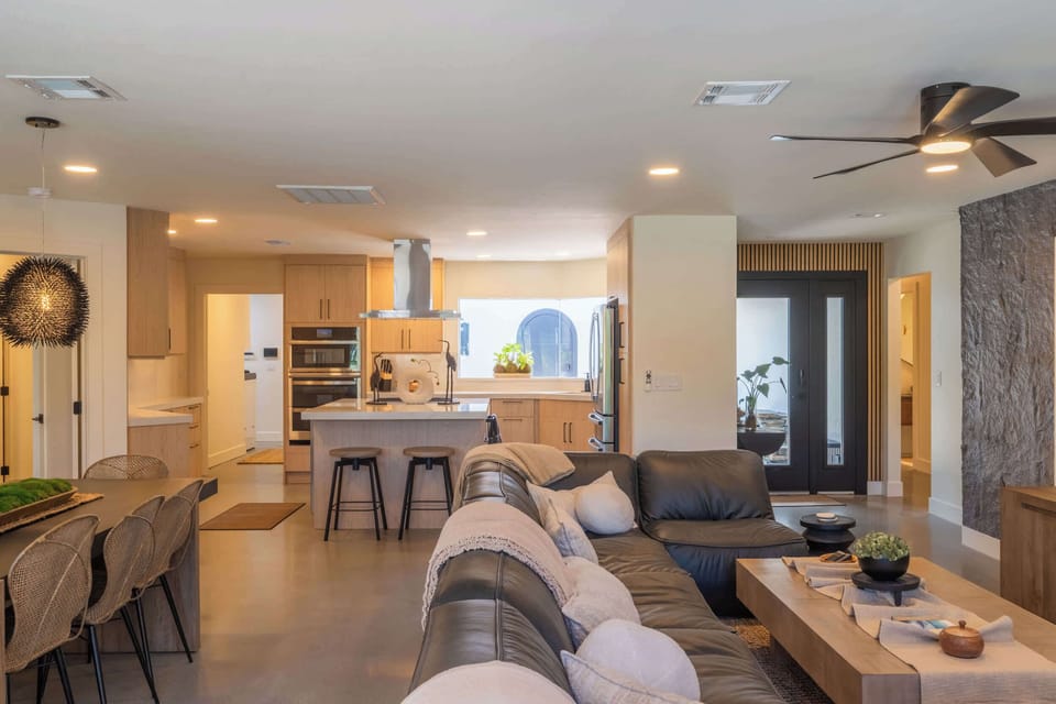 Open-concept living room connecting to the kitchen and dining area