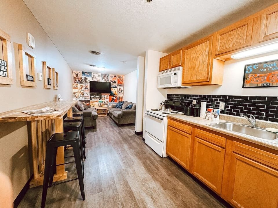 Kitchen w/ full range, microwave & bar seating for casual meals together.