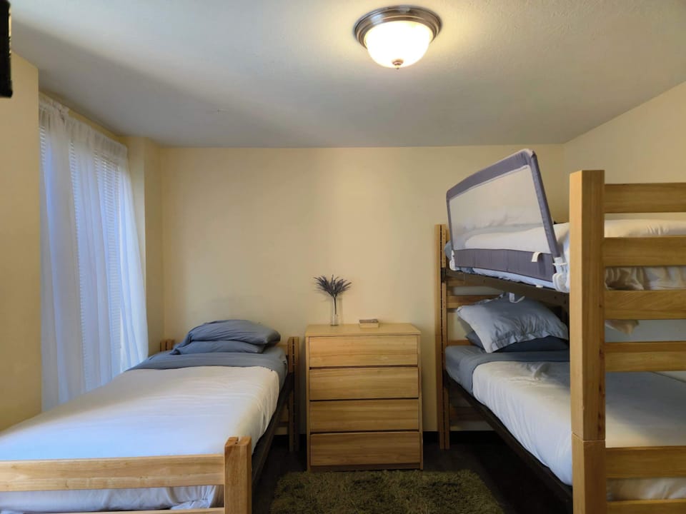 Comfortable shared bedroom with natural light and storage space