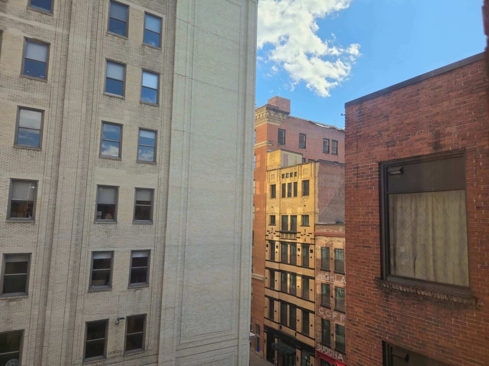 Scenic urban window view of historic brick and stone buildings