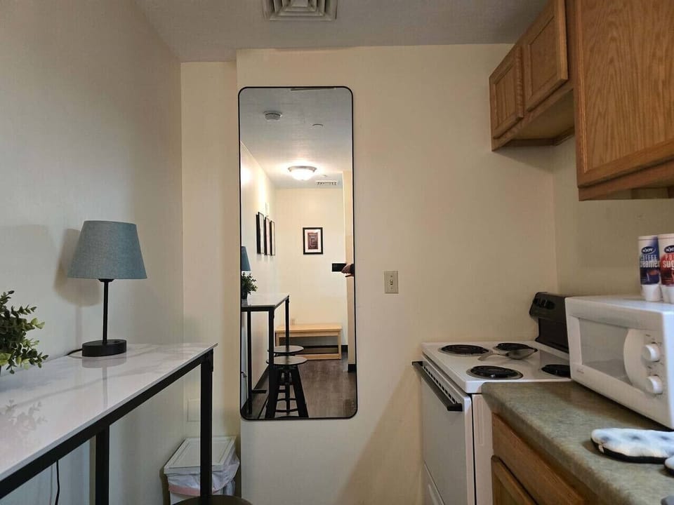 Kitchen area w/ table lamp & cabinetry for a functional prep space.