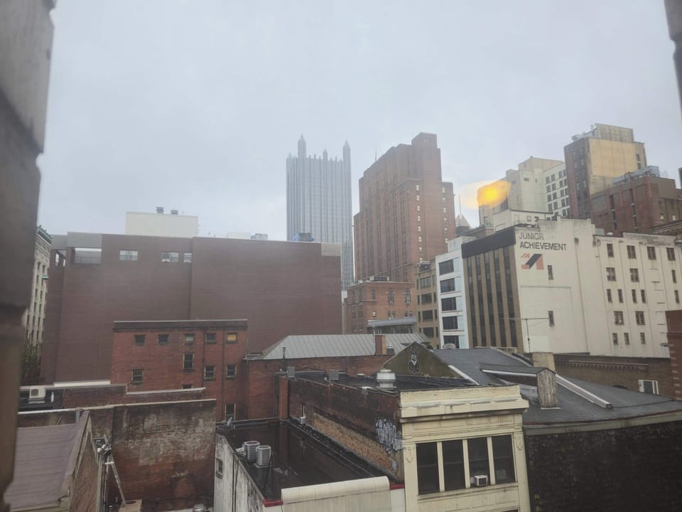 Urban view from the window towards downtown Pittsburgh, with historic buildings and classic city architecture.