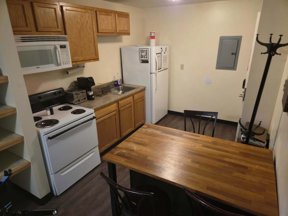 Dining and prep space with wood bar table, ideal for both meals and remote work