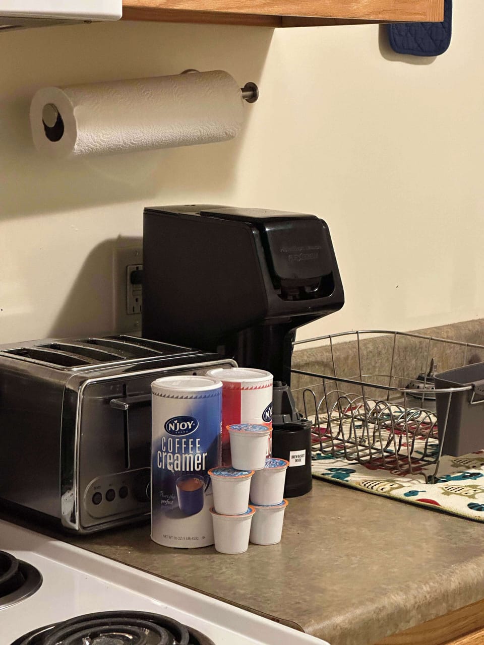 Coffee station essentials with single-serve cups, toaster, and modern drip machine