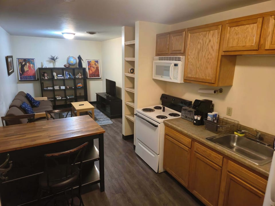 Inviting open-concept kitchen and living space with bookshelf and entertainment setup
