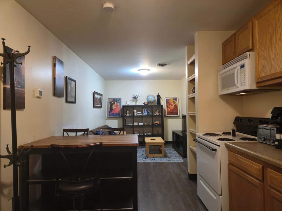 Warm and welcoming unit with framed artwork, wood finishes, and cozy furnishings