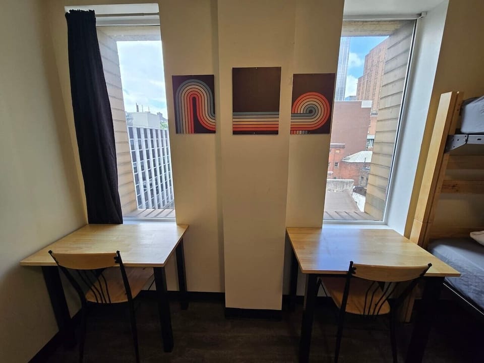 Two dedicated work desks with natural light and city views make the space ideal for remote work or studying.