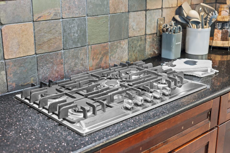 Gourmet kitchen setup with premium finishes and open flow into the dining area.