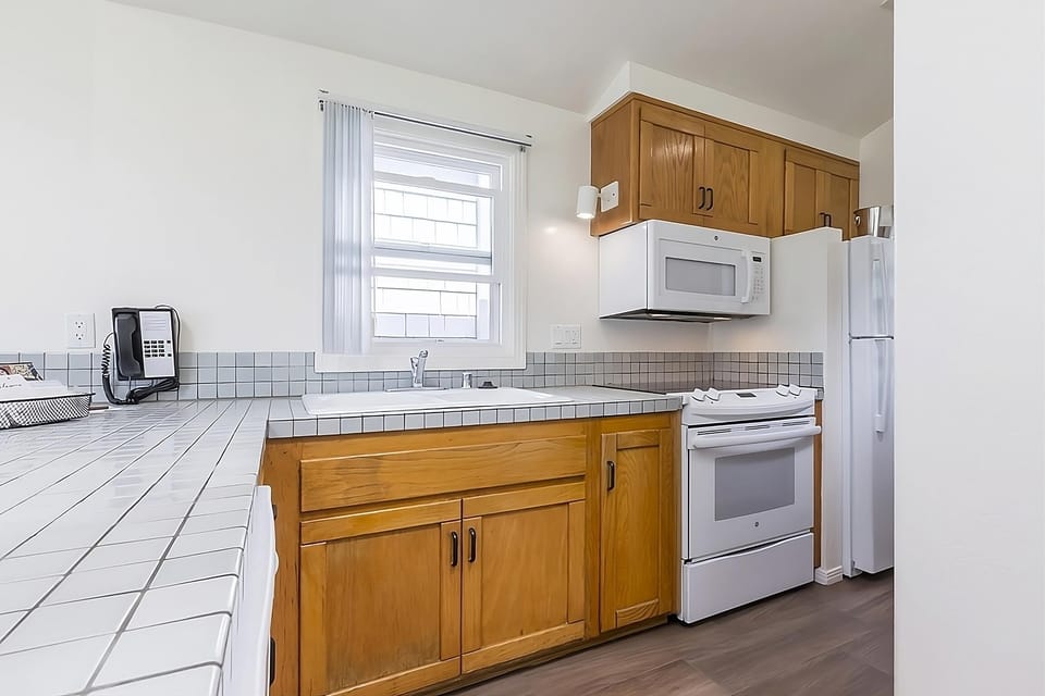 Cook simple meals comfortably in a bright, well-equipped kitchen.
