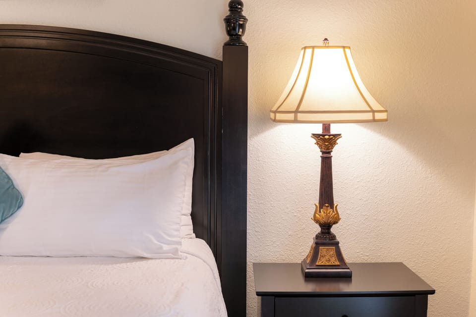 Relax with a book by the cozy bedside lamp glow.