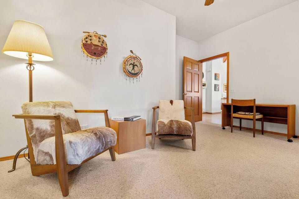 Private sitting room that serves as the entry to an upstairs suite — a quiet space to relax with a book, unwind, or enjoy a peaceful moment before heading into the bedroom and spacious ensuite bathroom with soaking tub.
