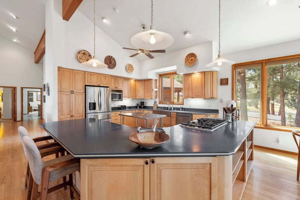 Spacious chef’s kitchen designed for gathering, featuring expansive prep space, a large island with seating, and everything you need for cooking memorable meals together.