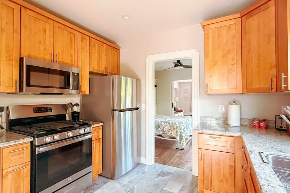 Fully equipped kitchen featuring a gas stove and oven, plus a full-size fridge and freezer. Perfect for cooking at home, with everything you need in a clean, modern space.