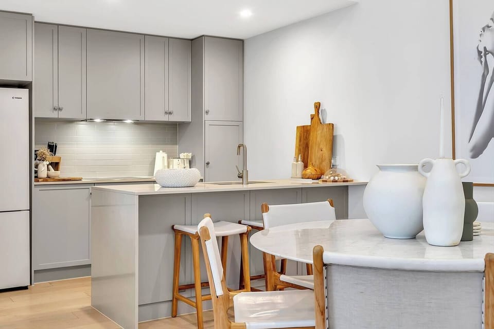 The fully equipped kitchen includes an espresso machine and modern appliances for effortless home cooking.