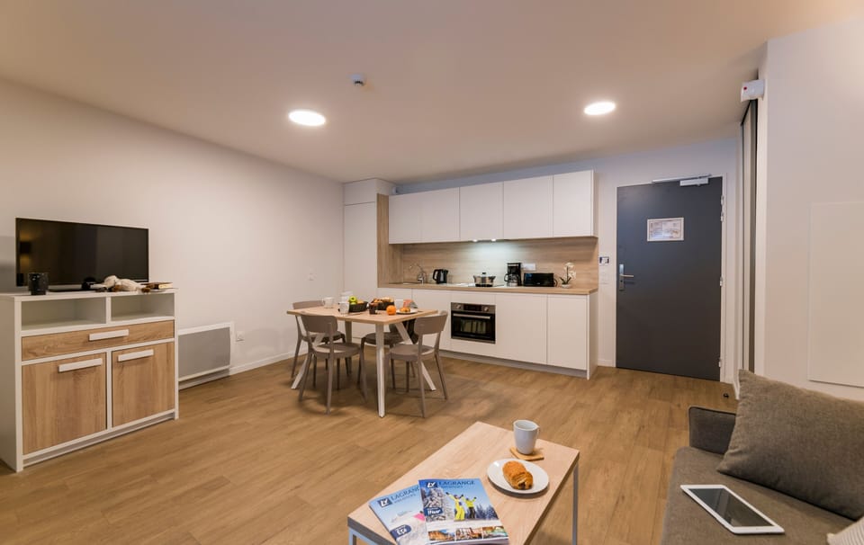 Bright and airy, this modern kitchen and dining area is designed for comfort, complete with thoughtful amenities and a delightful breakfast setup, ideal for starting your mountain adventures.