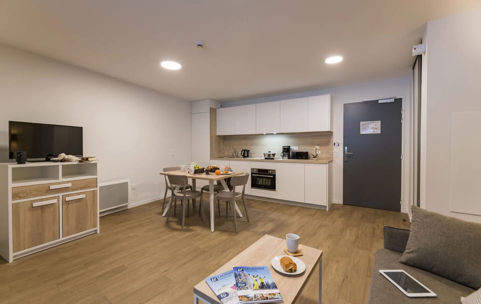 This cozy studio features a bright and modern kitchen area, perfect for preparing meals after a day on the slopes. Enjoy breakfast for two at the inviting dining table.