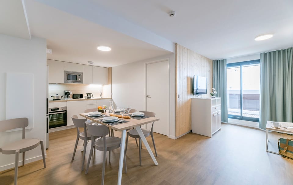 Experience modern elegance in this cozy mountain apartment featuring a bright open-plan kitchen and dining area, perfect for enjoying meals with loved ones while soaking in breathtaking views.