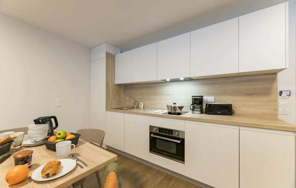 This modern kitchen is perfect for family meals, featuring a stylish dining area, sleek appliances, and plenty of natural light to start your day right before hitting the slopes.
