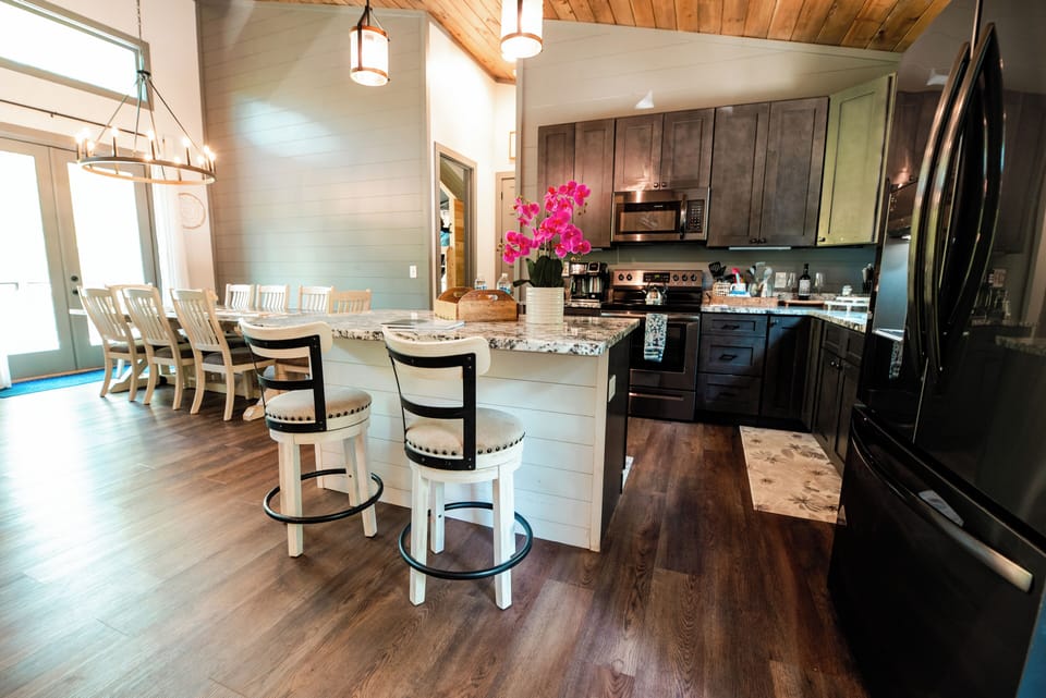 Spacious open kitchen with island seating and stylish dining area