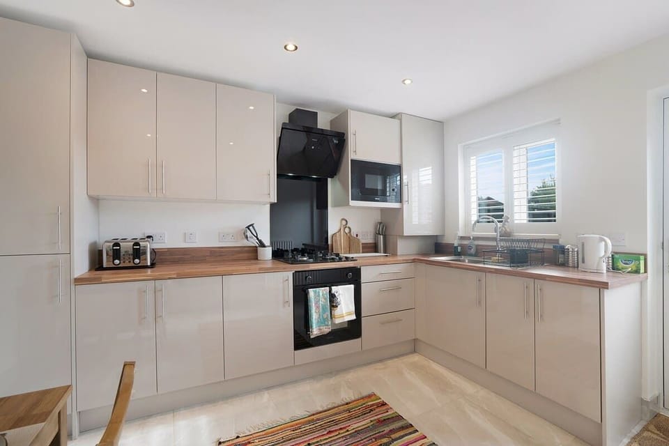 Kitchen equipped with all essentials, including a washer & dryer, oven, fridge and full cookware set.