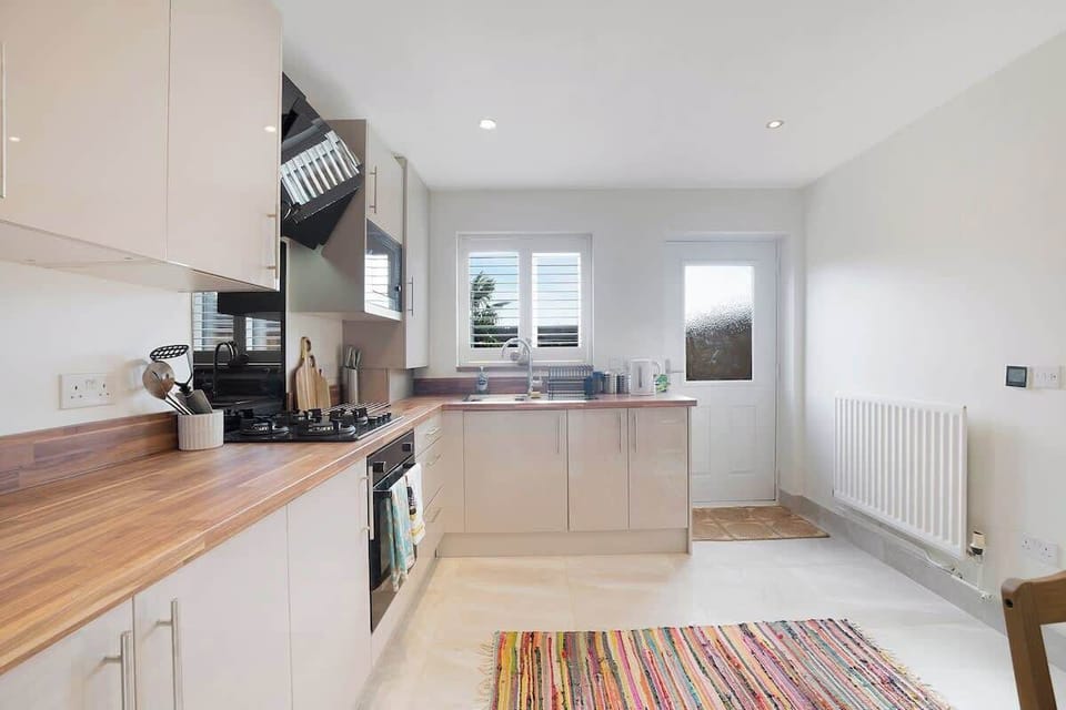 Kitchen equipped with all essentials, including a washer & dryer, oven, fridge and full cookware set.
